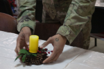 A soldier places a small centerpiece in preparation for Christmas dinner at the Yavoriv Combat Training Center in Yavoriv, Ukraine, Dec. 25, 2017. More than 220 of the 27th Infantry Brigade's soldiers were deployed to the Ukraine working alongside the Ukrainian Army.  Army photo by Sgt. Alexander Rector.